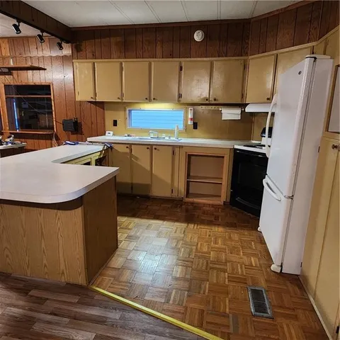 a kitchen with a refrigerator and a stove