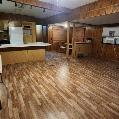 a view of a room with wooden floor