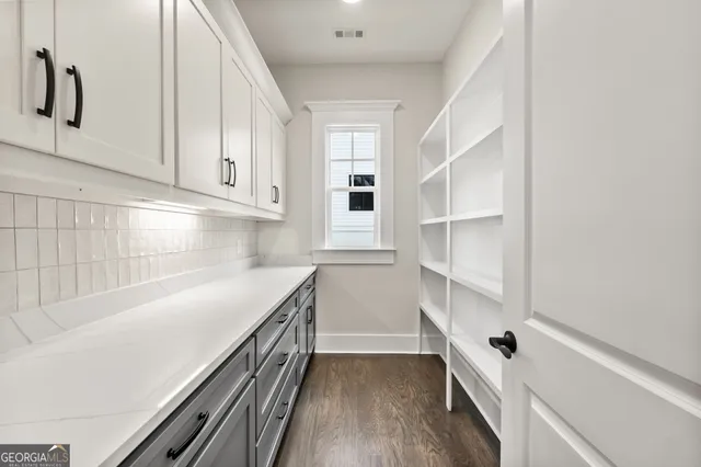 a kitchen with a cabinets and white appliances