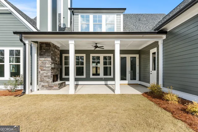 wooden floor fireplace and windows in an empty room