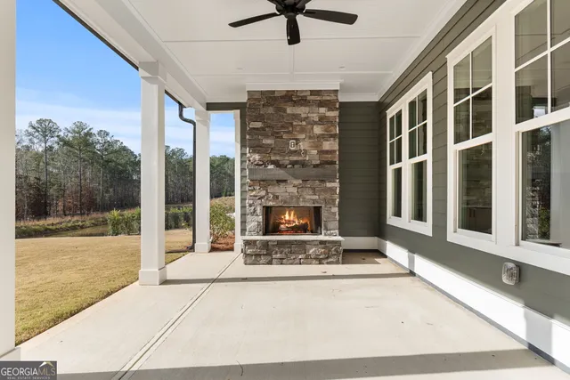 a large white kitchen with kitchen island a chandelier and wooden floors
