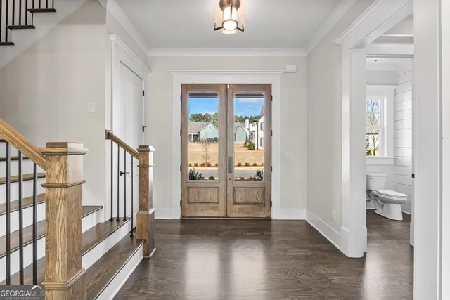 a kitchen with a sink stove and wooden floor