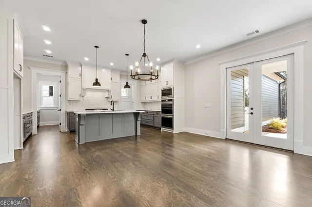 a kitchen with stainless steel appliances white cabinets and stove