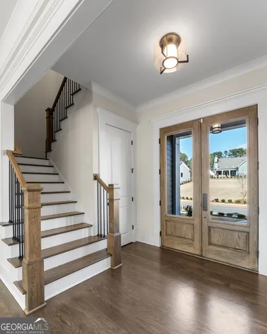 a view of a hallway with wooden floor and entryway