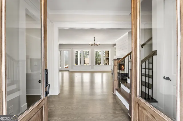 a view of front door and porch with wooden floor