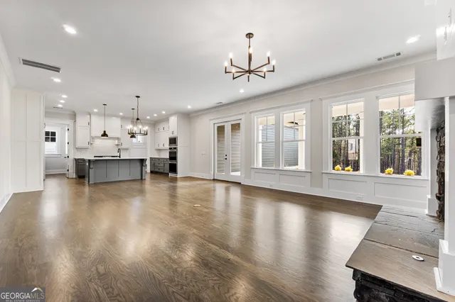 a view of a room with kitchen and windows