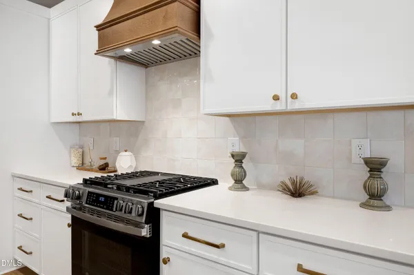 a kitchen with a stove and cabinets