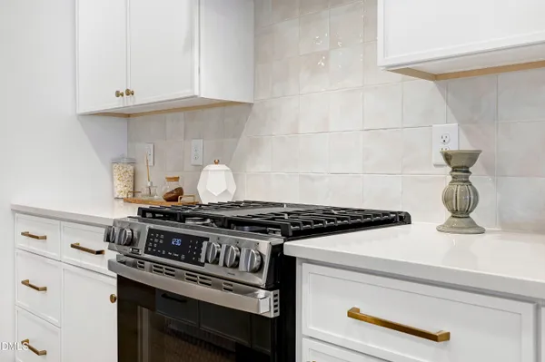 a stove top oven sitting inside of a kitchen