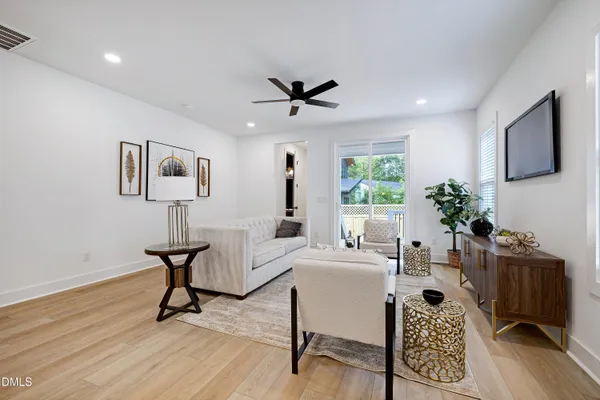 a living room with furniture a window and a potted plant