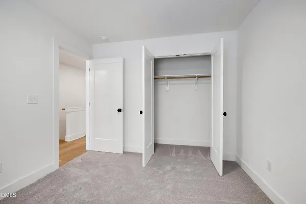 a view of an empty room and closet area