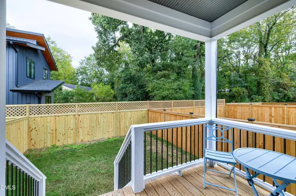 a view of a wooden deck and a backyard
