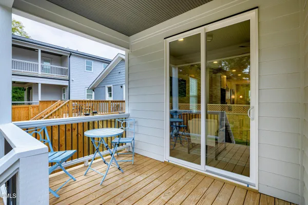a view of balcony with wooden floor and door