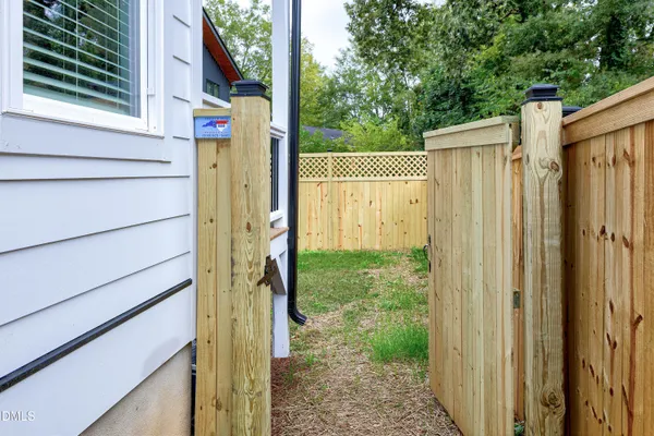 a view of a house with wooden fence
