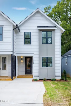 a view of a house with pool and a yard