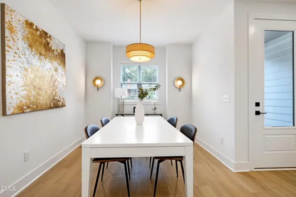 a view of a dining room with a table and chairs
