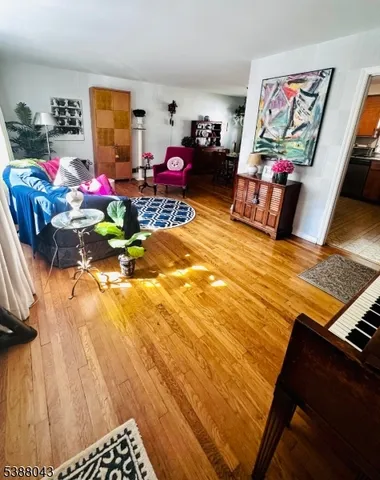 a living room with lots of furniture and wooden floor