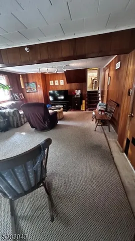 a living room with furniture a flat screen tv and a couch