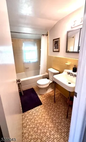 a bed room with a bed mirror and a night stand