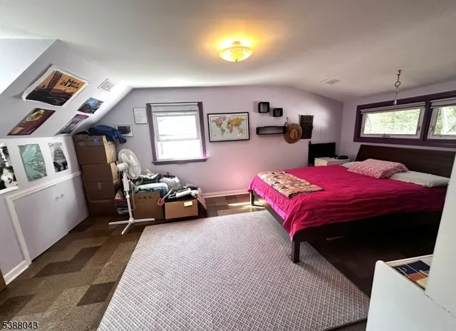 a view of bedroom with a bed and a window