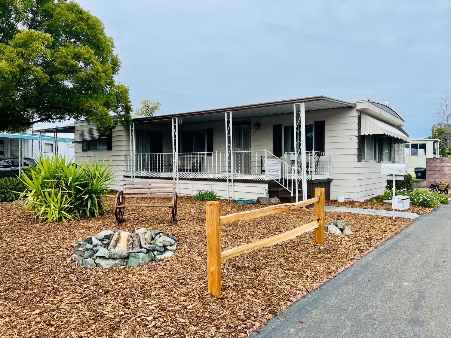 a view of a house with backyard and sitting area