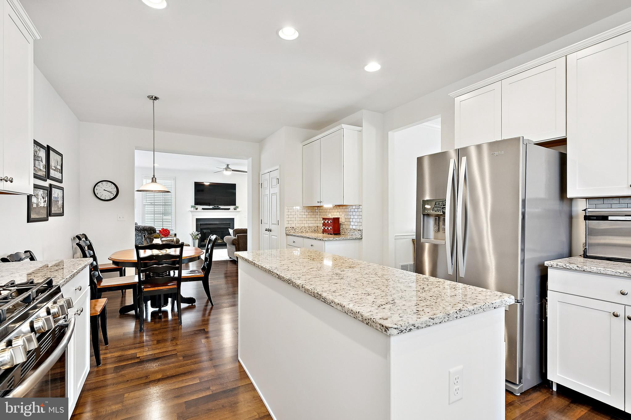 3 Antron Brown Way Chesterfield, NJ 08515 - Photo 14 of 28 a kitchen with stainless steel appliances kitchen island granite countertop a table chairs and a refrigerator