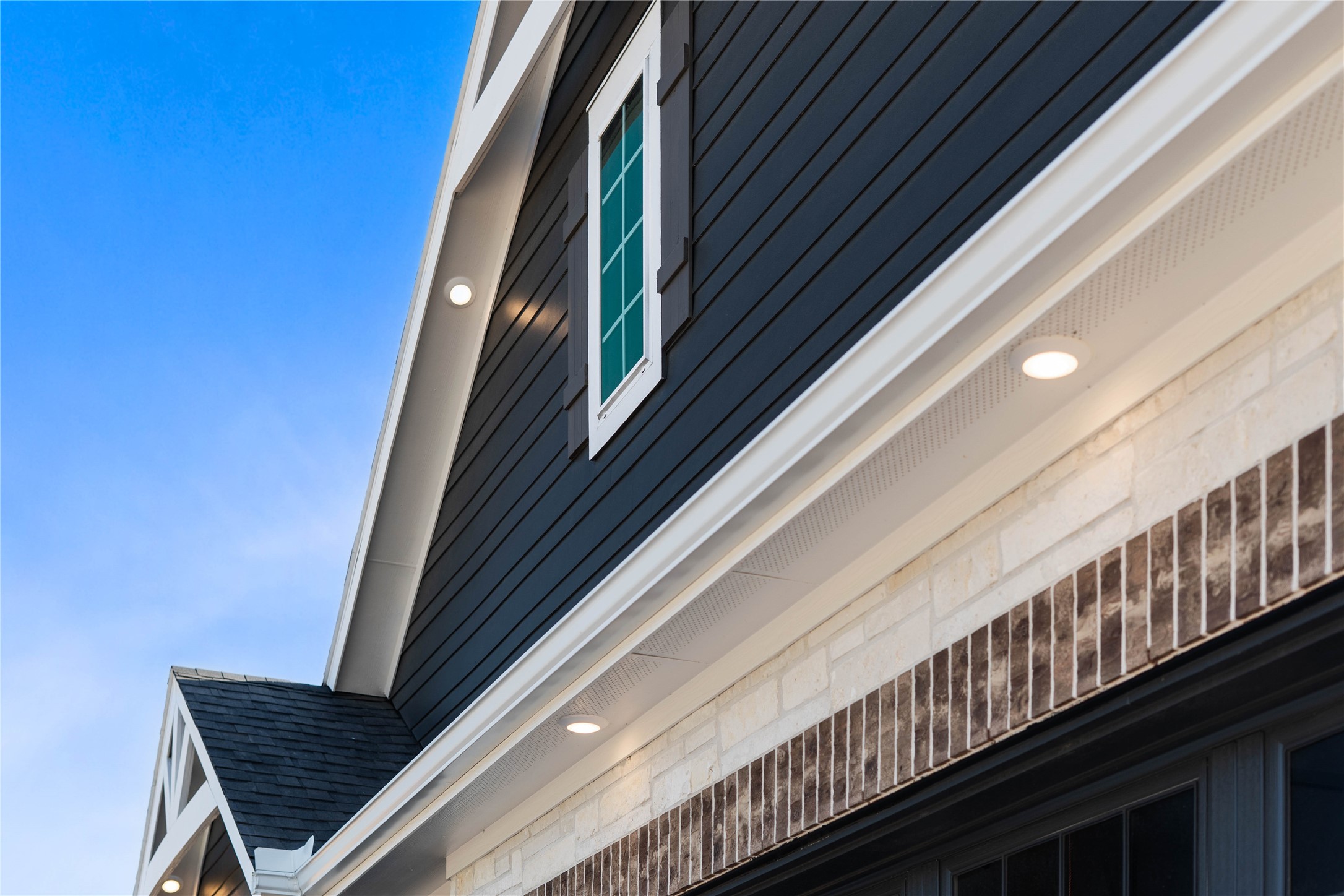 2114 Rowl Street Montgomery, TX 77316 - Photo 5 of 50 This modern farmhouse exterior seamlessly blends contemporary style with classic architectural elements, creating an immediate and lasting impression of luxury. Strategically placed LED pot lights provide a high-end, custom-built feel.