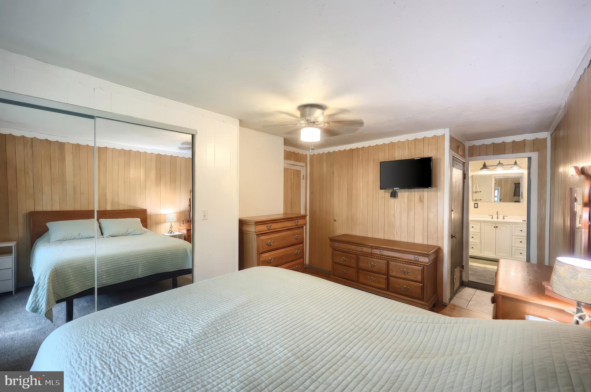 1111 Richmond Road Red Lion, PA 17356 - Photo 18 of 57 a bedroom with a large bed and a flat tv screen on dresser