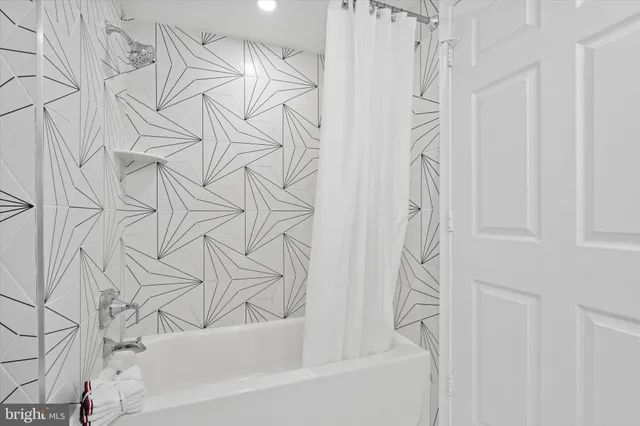 a bathroom with a bathtub and shower