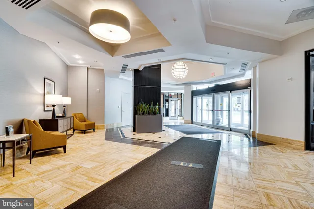a large white kitchen with stainless steel appliances granite countertop a stove and a sink