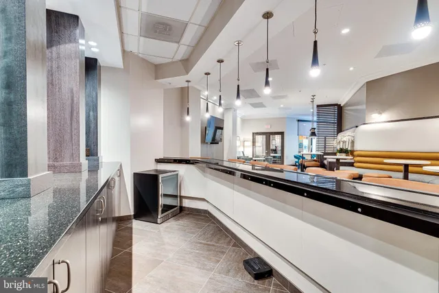 a living room with furniture and large windows