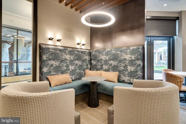 a living room with furniture a flat screen tv and kitchen view