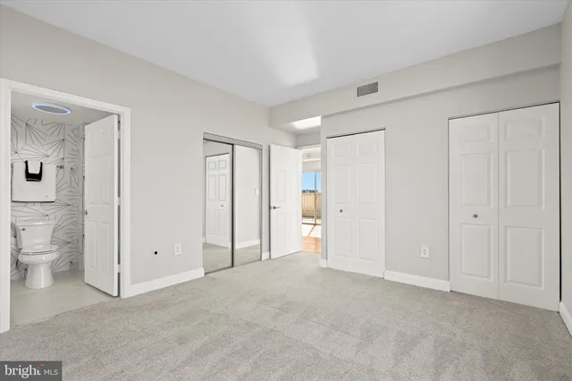 a view of an empty room and a bathroom