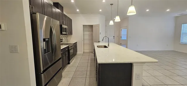 a kitchen with stainless steel appliances a refrigerator and a sink