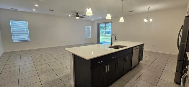 a kitchen with a sink a mirror and wooden floor