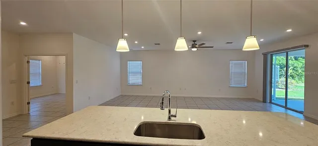 a view of a room with a chandelier furniture and windows