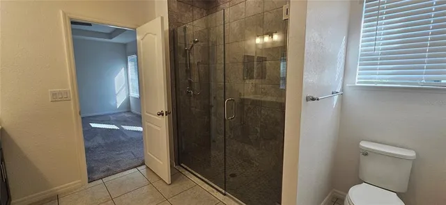 a bathroom that has a glass shower door