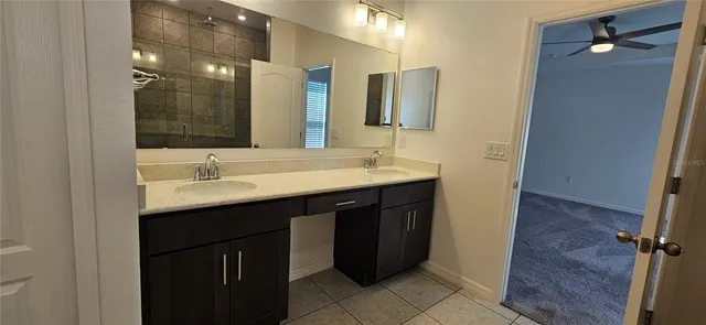 a bathroom with a double vanity sink and mirror