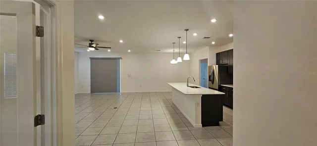 a view of a kitchen with a sink and a refrigerator