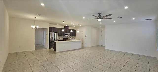 a large white kitchen with a white cabinets and stainless steel appliances