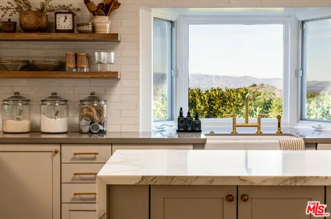 a kitchen with a sink and a large window