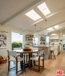 a kitchen with a table and chairs in it
