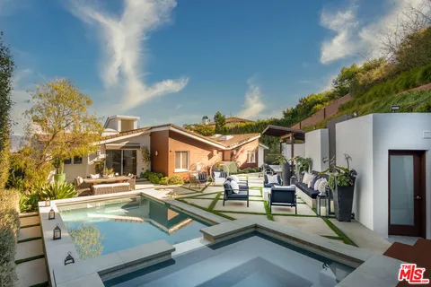 a view of a patio with swimming pool table and chairs