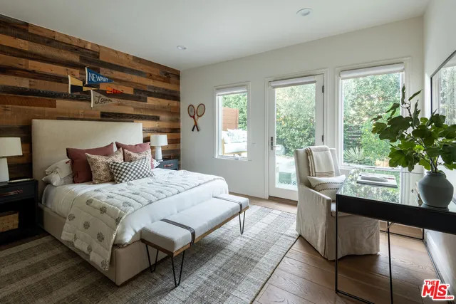 a bedroom with a large bed and a window