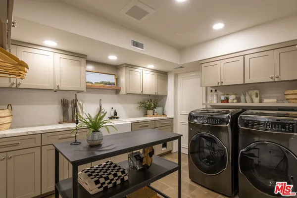 a kitchen with a sink a stove and cabinets