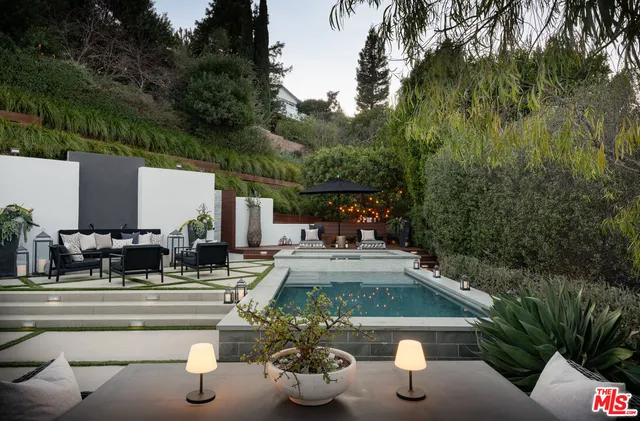 a view of swimming pool with outdoor seating and plants