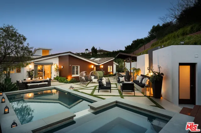 a view of a swimming pool with outdoor seating