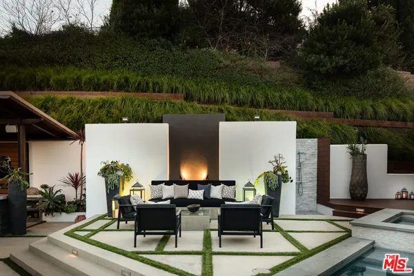 a view of a patio with table and chairs with wooden floor and plants