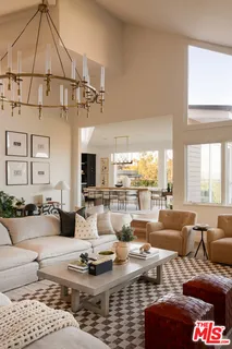 a living room with furniture or couch and a chandelier