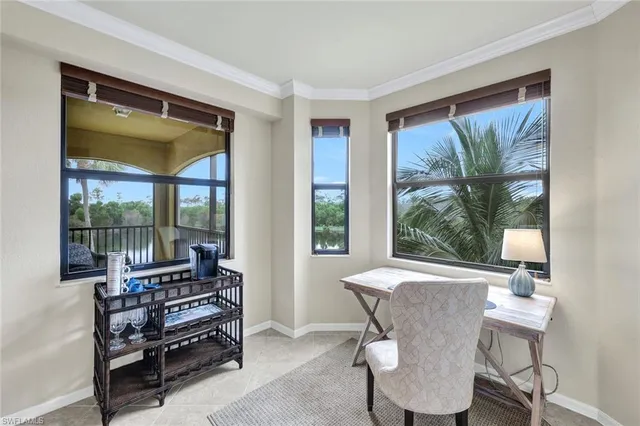 a view of a dining room with furniture large windows and wooden floor