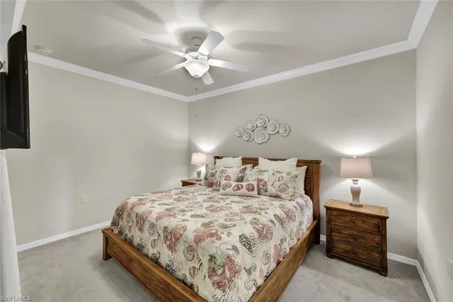 a bedroom with a bed and lamp on dresser